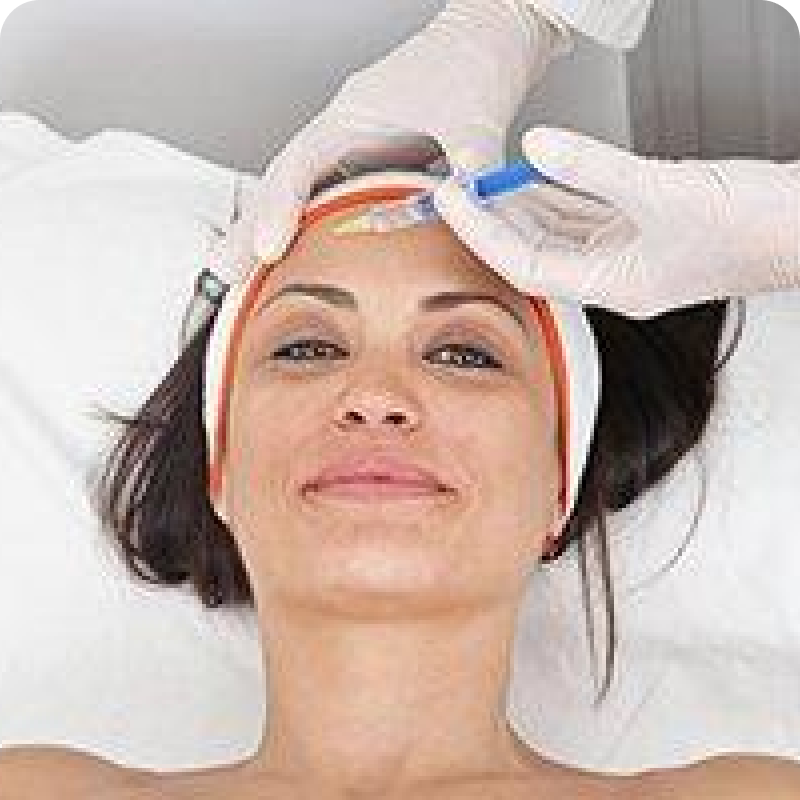 A woman getting her face waxed at the spa