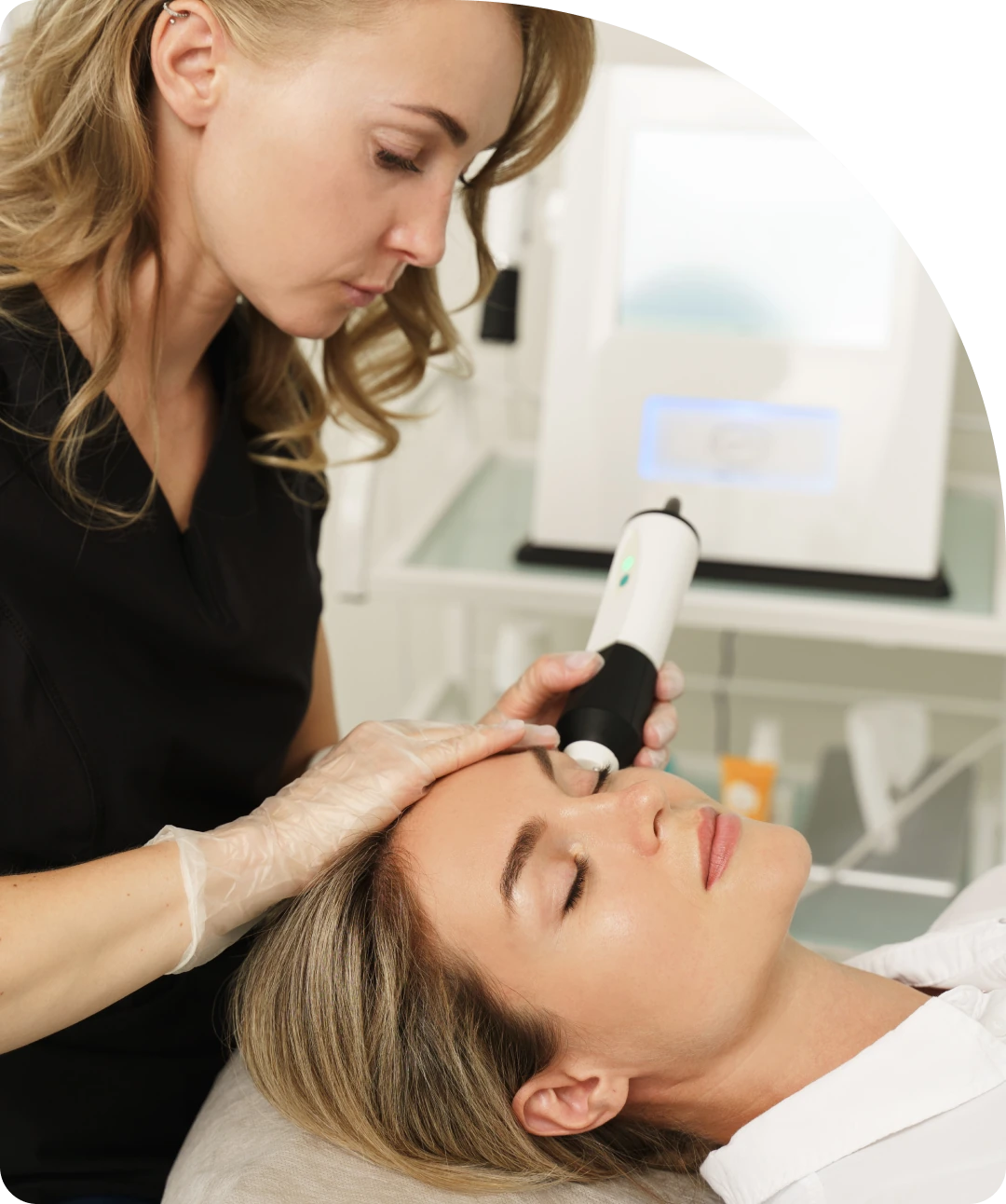 A woman is getting her hair cut by an esthetician.