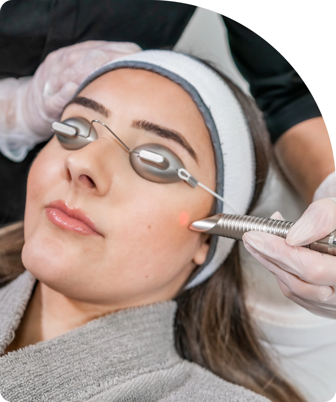 A woman getting her face waxed at the spa