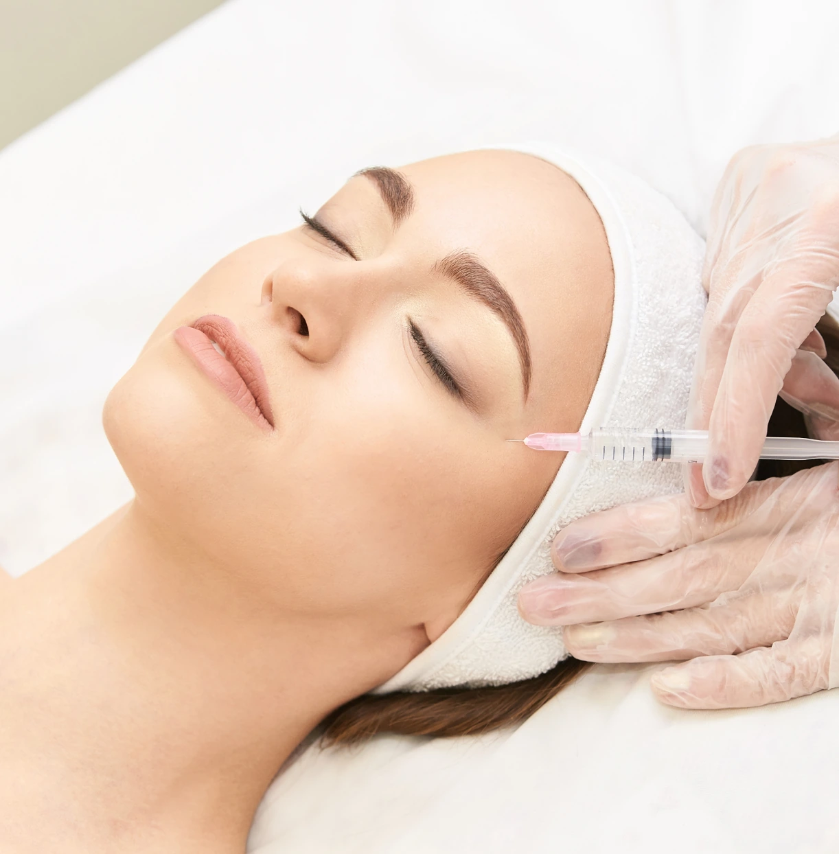 A woman getting her face waxed at the spa