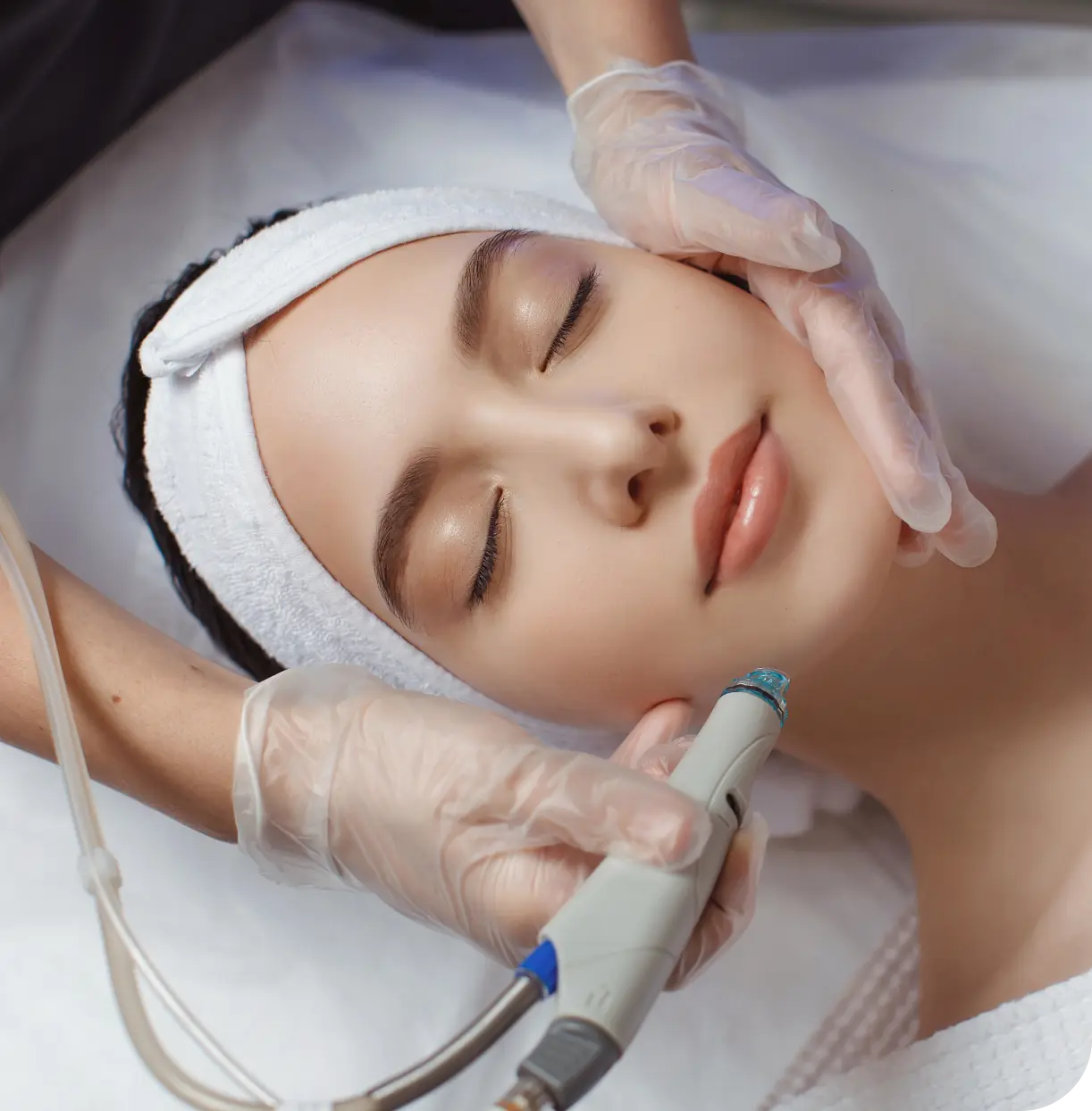 A woman getting her face waxed at the spa